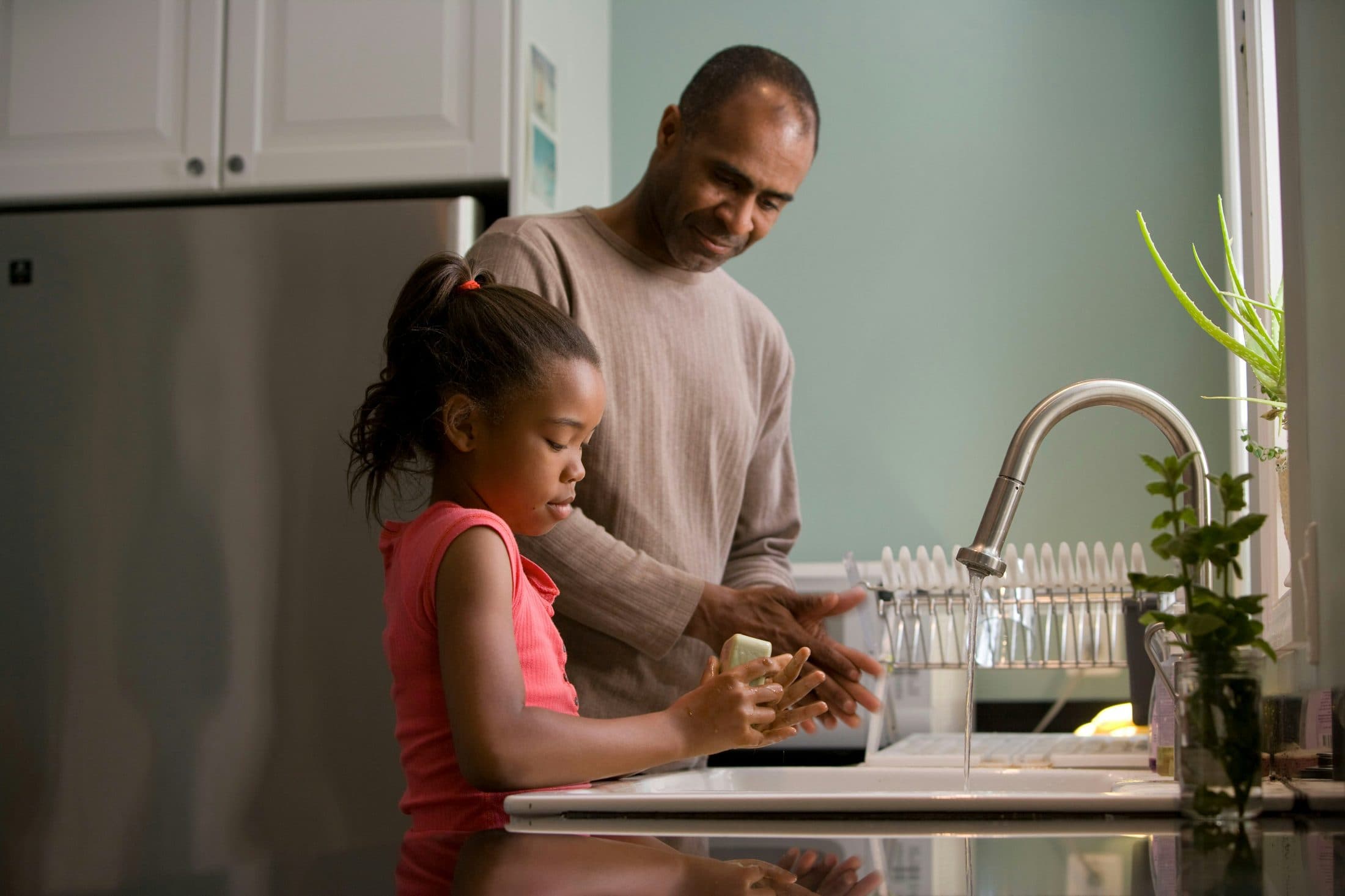 Parent and child cooking together in a kitchen